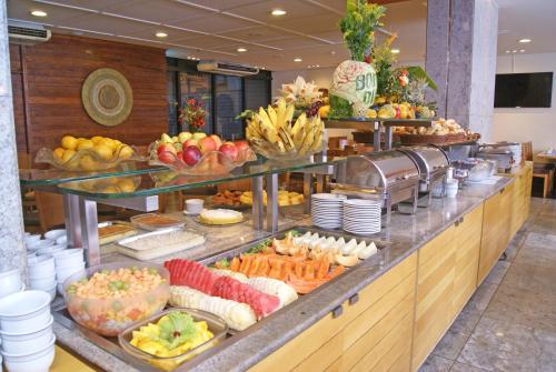 a buffet line with many different types of fruits and vegetables at Hotel Diogo in Fortaleza