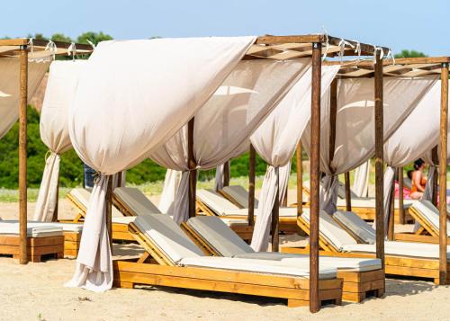 a bunch of lounge chairs sitting on the beach at Haus Eleonas in Kalives Poligirou