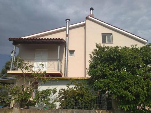 a house with a balcony on top of it at Grecos apartment in Preveza