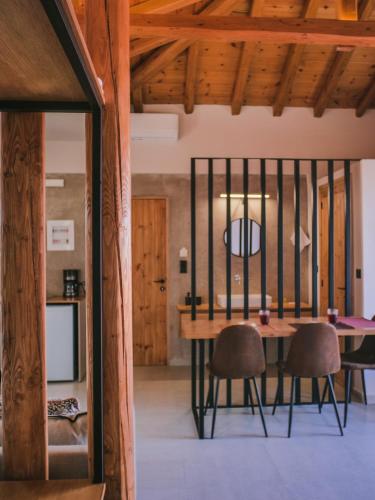 a dining room with a wooden table and chairs at Petrichor in Kalamata