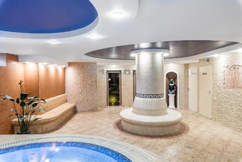 a lobby with a swimming pool and a building at Kerpė Hotel & SPA in Palanga