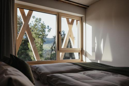 a bedroom with a window and a bed in front of it at Plattnerhof Viums in Natz-Schabs
