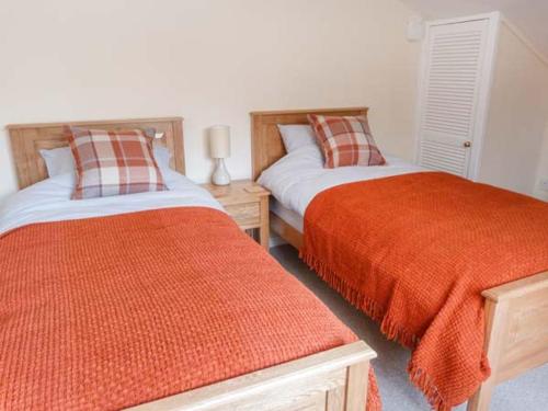 two beds sitting next to each other in a bedroom at Hillfoot in Kingussie