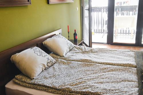 a bed with two pillows on it in a bedroom at Jovanovic Guest House in Ohrid