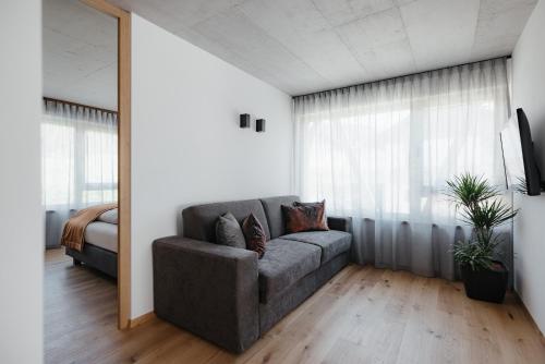 a living room with a couch and a bed at Plattnerhof Viums in Natz-Schabs