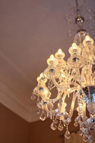 a glass chandelier hanging from a ceiling at Schloss Fellin Boutique Hotel and Spa in Viljandi