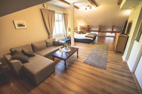 a living room with a couch and a table at Cafe-Restaurant & Hotel Saima in Savonlinna