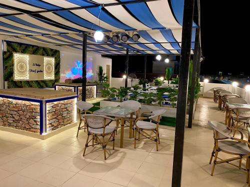 a patio with tables and chairs under a tent at La Boutique Residence in Hurghada