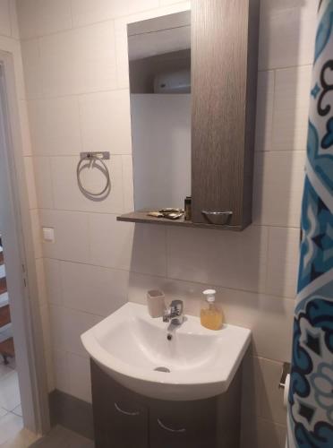 a bathroom with a sink and a mirror at Eutyxia House in Gaios Walk to Center & Beaches in Gaios