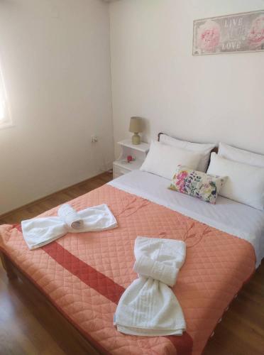 a bedroom with a bed with two towels on it at Eutyxia House in Gaios Walk to Center & Beaches in Gaios