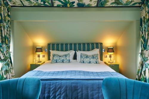 a bedroom with a large bed and a large window at Hotel du Vin Exeter in Exeter