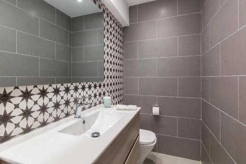 a bathroom with a white sink and a toilet at L'aviador de Can Ton in Sant Llorenc Savall