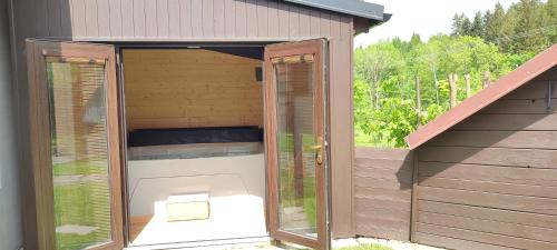an outbuilding with a toilet inside of it at Apartmány Anna s welness in Trojanovice