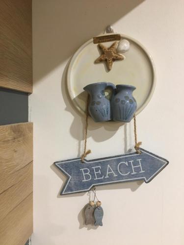 a sign that says beach with two vases and a star at Apartment Ariella in Jūrmala