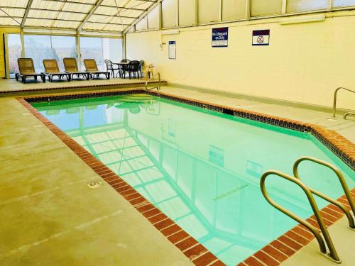 a large swimming pool with chairs and a table at Quality Inn Price Gateway to Moab National Parks in Price