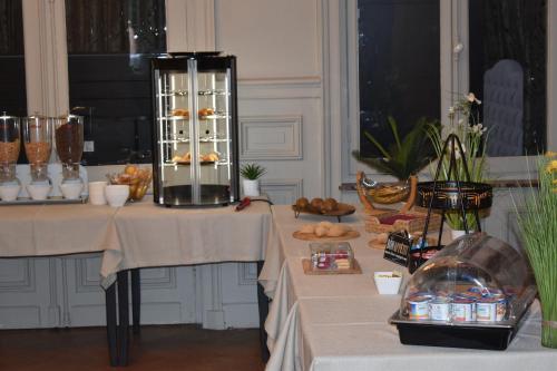 two tables with pastries and bread on them at Logis Manoir de Fourcy in Corbehem