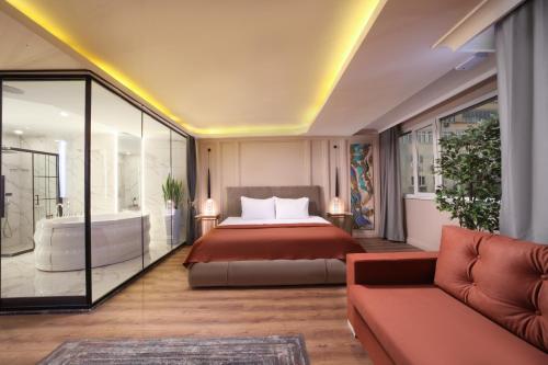 a bedroom with a bed and a tub and a couch at Harbiye Residence in Istanbul