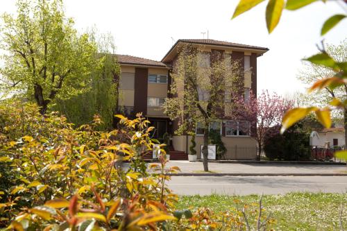 a building with a lot of flowers in front of it at Hotel Mini Palace - Country House in Molinella