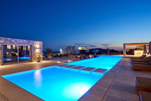 a swimming pool with blue lights on a building at Ionic Suites in Super Paradise Beach