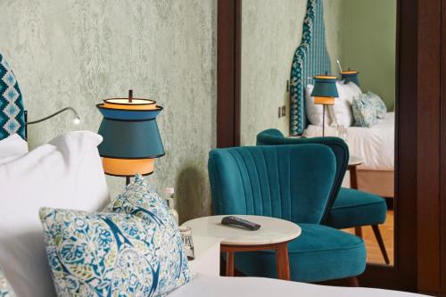 a hotel room with a bed and two chairs at Hotel du Vin Exeter in Exeter