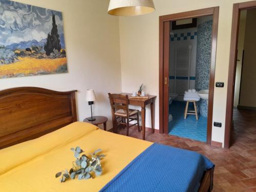 a bedroom with a bed and a chair at Poggio Desto Bed & Breakfast in Quarrata