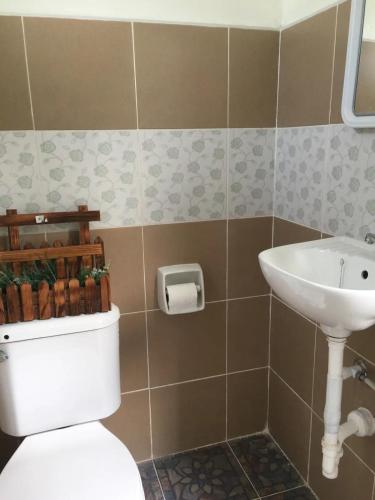 a bathroom with a toilet and a sink at Hope Inn in Bolod