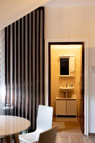 a bathroom with a sink and a mirror at Delux Apartmani Požarevac in Požarevac