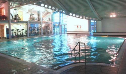 a large swimming pool in a large building at Lakeside 18 in Warton