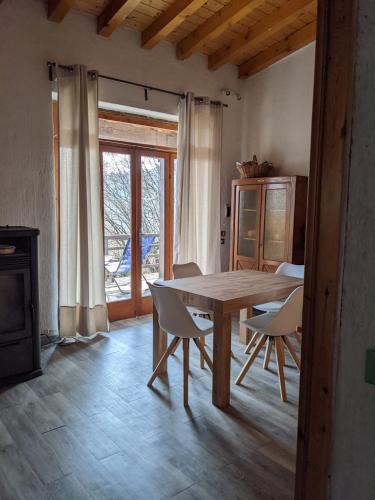 a dining room with a wooden table and chairs at La casetta nel bosco in Salò