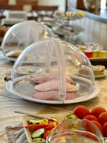 a plate of food with meat and vegetables on a table at Hotel Hilgers in Düren - Eifel