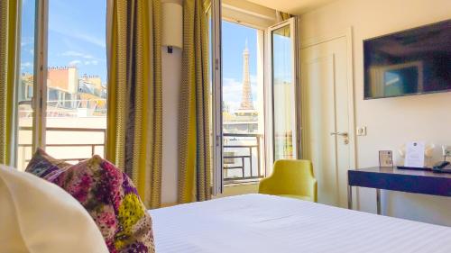 a hotel room with a view of the eiffel tower at Hôtel Gustave in Paris