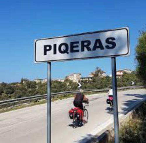 two people riding motorcycles on a road with a sign at Amazing View Apartments at Kroi i Gjine, Piqeras in Piqeras