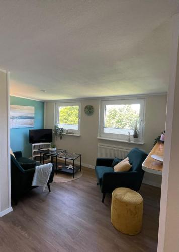 a living room with two couches and a tv at Lüttje Najade in Borkum