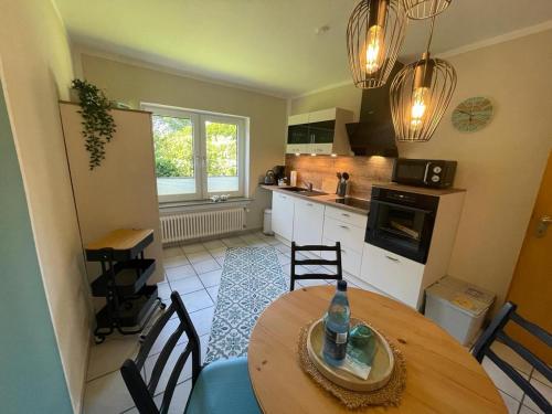 a kitchen with a table and chairs in a room at Lüttje Najade in Borkum