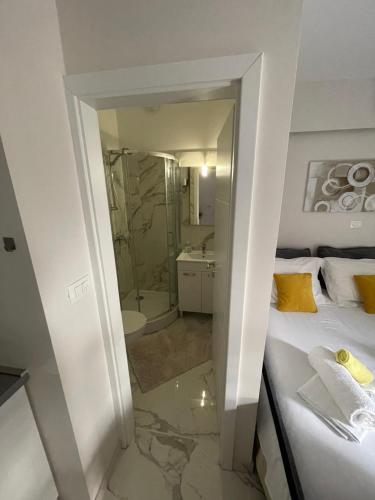 a small bathroom with a bed and a shower at Apartment Nikola in Matulji