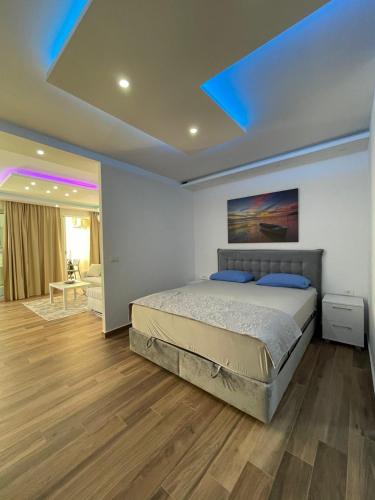a bedroom with a bed and a blue ceiling at Coco apartments in Petrovac na Moru