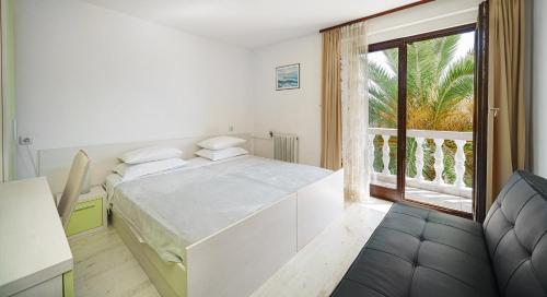 a bedroom with a bed and a large window at B&B Sidro in Vodice