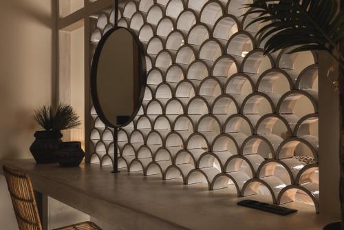 a mirror on a wall next to a table at Panorama Inn in Lithakia