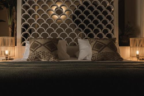 a bedroom with a bed with pillows and a wall at Panorama Inn in Lithakia