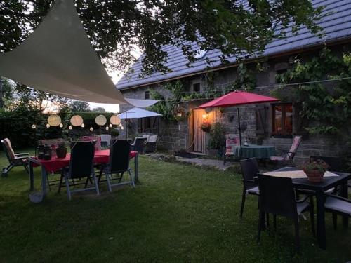 a group of tables and chairs in a yard at Maison de Campagne in Sarroux