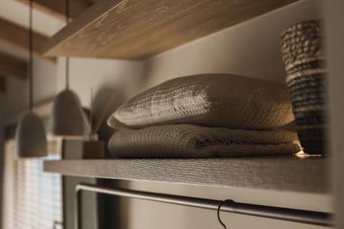 a stack of towels sitting on a shelf in a kitchen at Panorama Inn in Lithakia