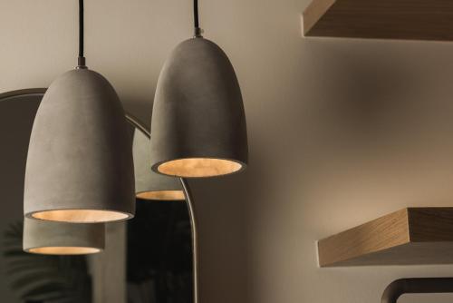two black pendant lights hanging from a wall at Panorama Inn in Lithakia