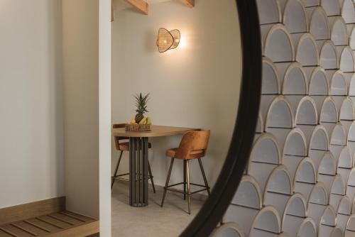 a dining room with a table and a mirror at Panorama Inn in Lithakia