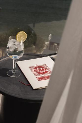a table with a glass of water and a napkin and a book at Panorama Inn in Lithakia