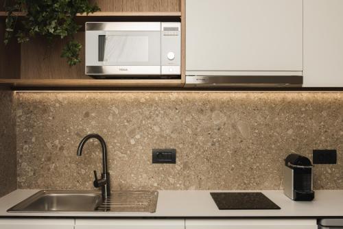 a kitchen with a sink and a microwave at Panorama Inn in Lithakia