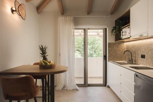 a kitchen with a table with a bowl of fruit on it at Panorama Inn in Lithakia