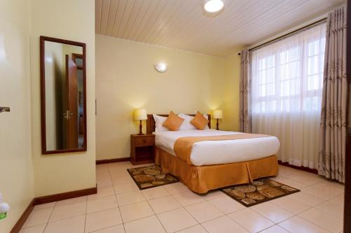 Una cama o camas en una habitación de The Cycads Suites