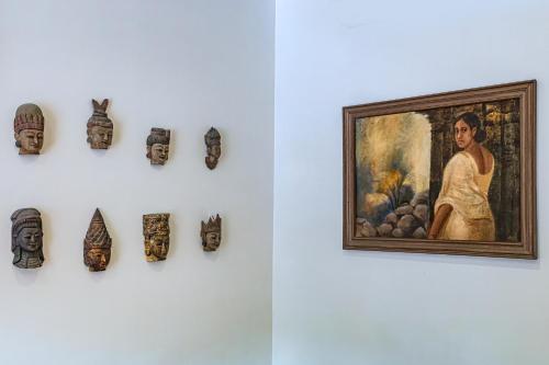 a exhibit in a museum with a painting and artifacts at Saffronstays Casa Del Palms, Alibaug - luxury pool villa with chic interiors, alfresco dining and island bar in Alibaug