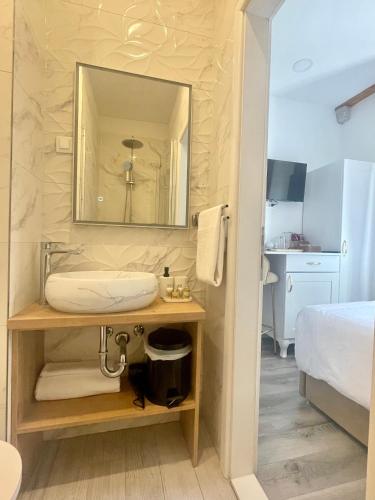 a bathroom with a sink and a mirror at Ida Old Town Rooms in Dubrovnik