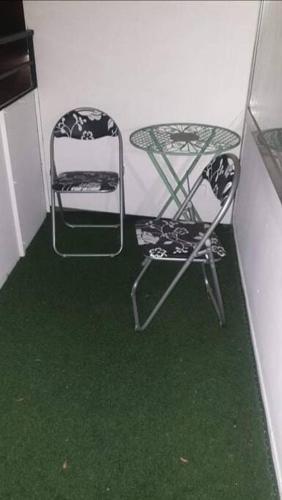 two chairs and a table in a room with green grass at Apartment 55 I Cental Hof I WiFi I TV in Hof
